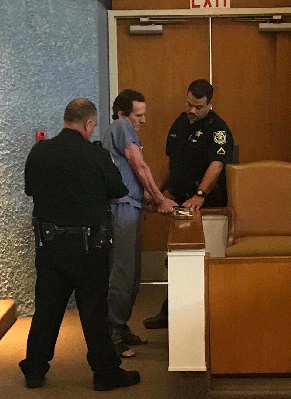 Monroe County Sheriff’s Office deputies take fingerprints from a shackled Robert Schminky on March 20, 2018, after Circuit Judge Luis Garcia sentenced him to two life terms for his 2015 shootout with deputies and a Florida Highway Patrol trooper.