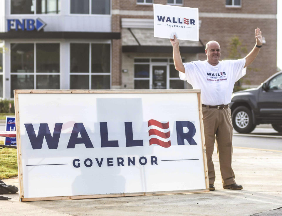 Bob Rosson holds a sign supporting Bill Waller during a primary runoff election at the Oxford Conference Center in Oxford, Miss. on Tuesday, Aug. 27, 2019. Mississippi voters are choosing a Republican nominee for governor, either second-term Lt. Gov. Tate Reeves or retired state Supreme Court Chief Justice Bill Waller. (Bruce Newman/The Oxford Eagle via AP)