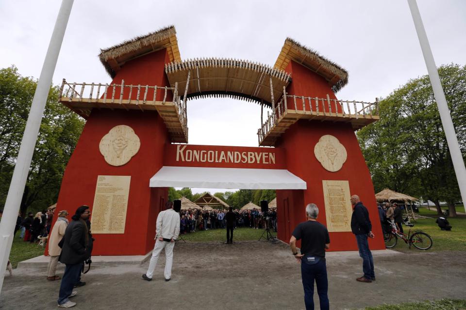 Guests attend the opening of the "Congo Village" in Oslo May 15, 2014. Displaying 80 people in a human zoo in Oslo's most elegant park, two artists hope their "Congo Village" display will help erase what they say is Norwegians' collective amnesia about racism. The Congo Village - which 100 years ago displayed African tribes, attracting 1.4 million visitors over four months - will this time exhibit volunteers taking turns living on show in makeshift huts, resembling a traditional sub-Saharan village. Picture taken May 15, 2014. REUTERS/Lise Aserud/NTB Scanpix (NORWAY - Tags: SOCIETY) ATTENTION EDITORS - THIS IMAGE HAS BEEN SUPPLIED BY A THIRD PARTY. FOR EDITORIAL USE ONLY. NOT FOR SALE FOR MARKETING OR ADVERTISING CAMPAIGNS. NORWAY OUT. NO COMMERCIAL OR EDITORIAL SALES IN NORWAY. THIS PICTURE IS DISTRIBUTED EXACTLY AS RECEIVED BY REUTERS, AS A SERVICE TO CLIENTS