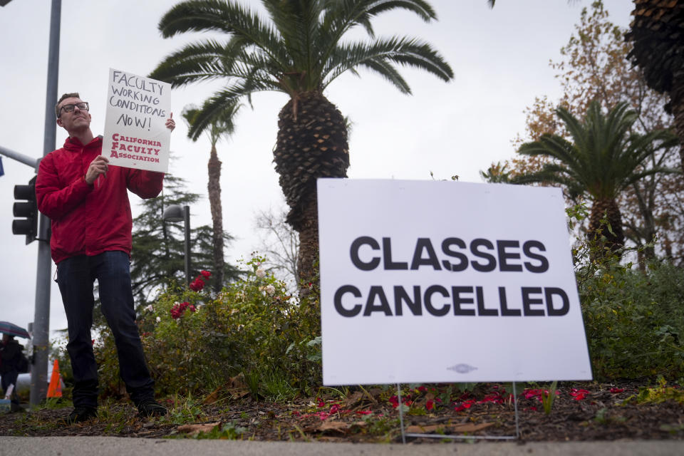 Librarian Chris Bulock, pickets outside the Cal State Northridge campus Monday, Jan. 22, 2024, in Northridge, Calif. More than 30,000 professors, librarians, plumbers, electricians, and other workers at California State University, the largest public university system in the U.S., have started a weeklong strike on Monday to demand higher wages. (AP Photo/Marcio Jose Sanchez)