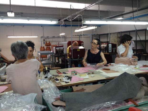 Designer Mariza Scotch (wearing glasses) working with handbag manufacturers in Italy. Photo: Courtesy of Mariza Scotch