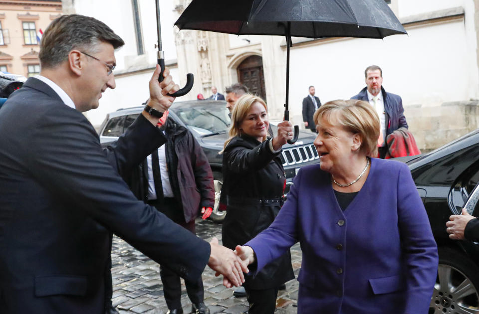 German Chancellor Angela Merkel, right, shakes hands with Croatia's prime minister Andrej Plenkovic in Zagreb, Croatia, Wednesday, Nov. 20, 2019. will attend the European Peoples Party (EPP) congress in the Croatian capital. (AP Photo/Darko Bandic)