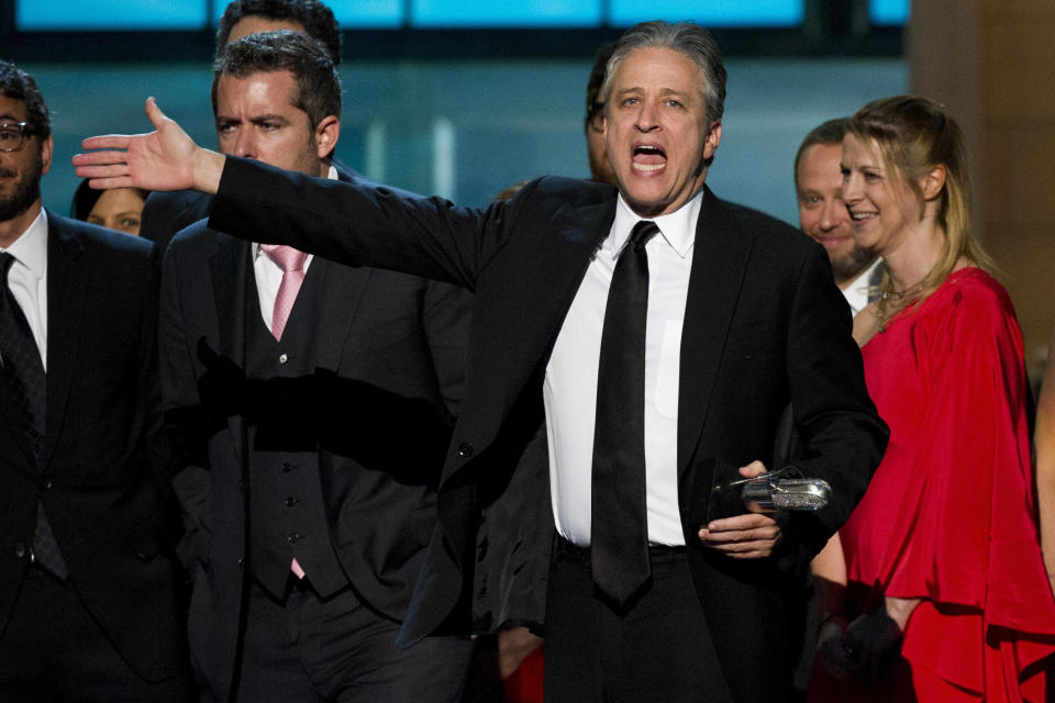 In this April 28, 2012 photo, Jon Stewart from "The Daily Show with Jon Stewart," appears onstage with his staff at The 2012 Comedy Awards in New York. The Comedy Awards will air on Sunday, May 6 at 9:00 p.m. EST on Comedy Central. (AP Photo/Charles Sykes, file)