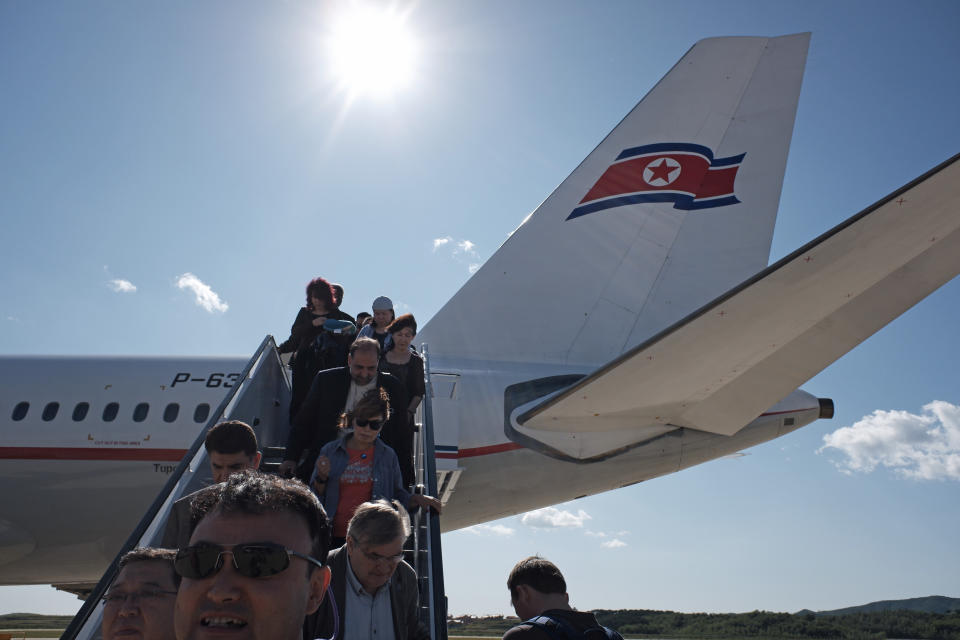 Passengers including foreign journalists invited for the 70th anniversary of North Korea's founding day, arrive on a plane at the airport in Pyongyang, North Korea, Friday, Sept. 7, 2018. North Korea will be staging a major military parade, huge rallies and reviving its iconic mass games on Sunday to mark its 70th anniversary as a nation. (AP Photo/Kin Cheung)