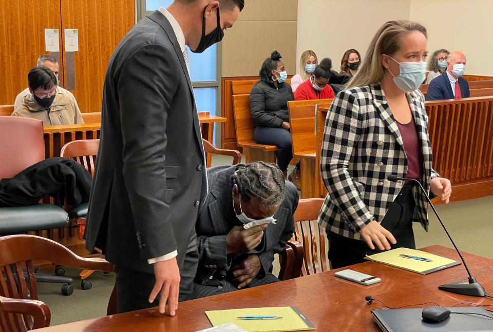 Anthony Broadwater breaks down crying Monday, Nov. 22, 2021, in Syracuse, N.Y., when a judge overturned his 40-year-old rape conviction. With him are his lawyers David Hammond (left) and Melissa Swartz. Broadwater, who spent 16 years in prison, was cleared Monday by a judge of raping Sebold when she was a student at Syracuse University, an assault she wrote about in her 1999 memoir, "Lucky."