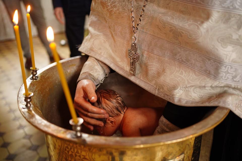 <span class="caption">Baptism is an important part of the sacraments of the Eastern Orthodox Church.</span> <span class="attribution"><a class="link " href="https://www.gettyimages.com/detail/photo/the-baby-is-lowered-into-the-font-at-the-baptism-in-royalty-free-image/1329373720?adppopup=true" rel="nofollow noopener" target="_blank" data-ylk="slk:Andrey Sayfutdinov/iStock / Getty Images Plus;elm:context_link;itc:0;sec:content-canvas">Andrey Sayfutdinov/iStock / Getty Images Plus</a></span>