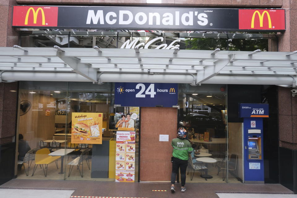 A sign on the door of a McDonald's as a person enters after earlier problems in the fast food restaurant, in Bangkok, Friday, March 15, 2024. System failures at McDonald’s have been reported worldwide, shuttering some restaurants for hours and leading to social media complaints. The fast food chain called the problems Friday a “technology outage” that is being fixed and apologized for the inconvenience. The Chicago-based burger giant said the problems aren't related to a cybersecurity issue. McDonald’s in Japan posted on X, formerly Twitter, that “operations are temporarily out at many of our stores nationwide.” (AP Photo/ David Cohen)