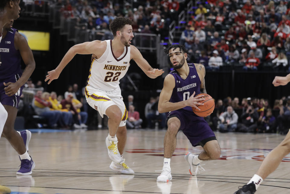 Northwestern's Boo Buie (0) is defended by Minnesota's Gabe Kalscheur (22) during the second half of an NCAA college basketball game at the Big Ten Conference tournament, Wednesday, March 11, 2020, in Indianapolis. Minnesota won 74-57. (AP Photo/Darron Cummings)