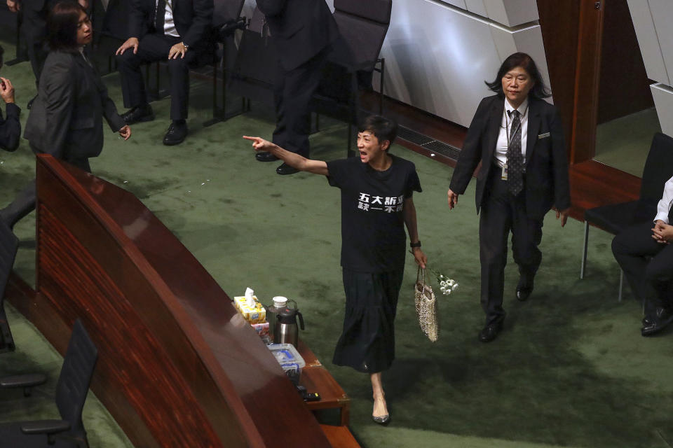 Pro-democracy lawmaker Tanya Chan shouts at Hong Kong Chief Executive Carrie Lam during a question and answer session with lawmakers at the chamber of the Legislative Council in Hong Kong, Thursday, Oct. 17, 2019. (AP Photo/Mark Schiefelbein)