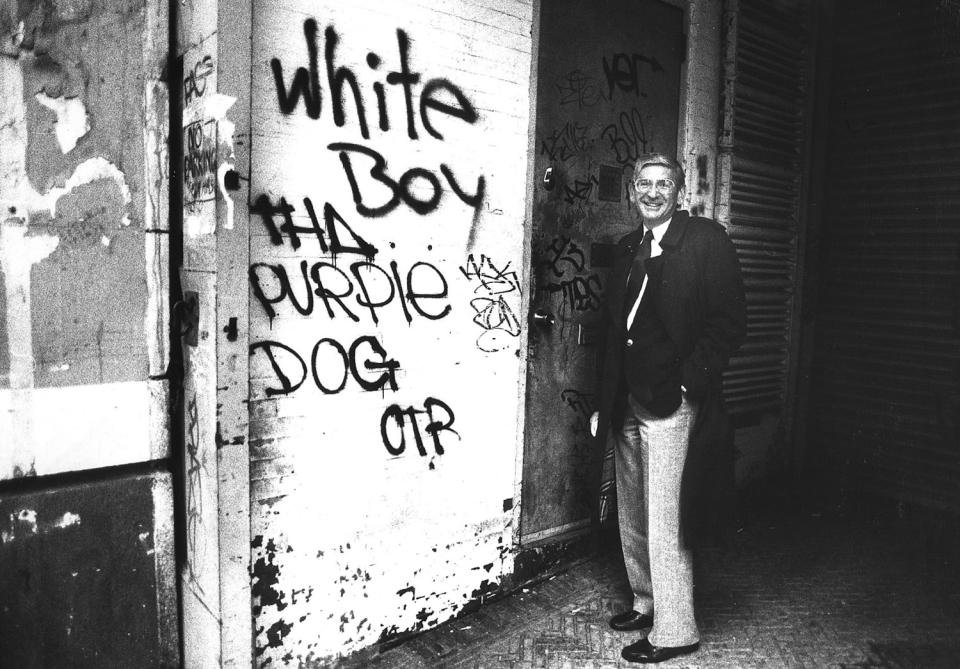 Eli Broad stands next to graffiti in New York in 1986.