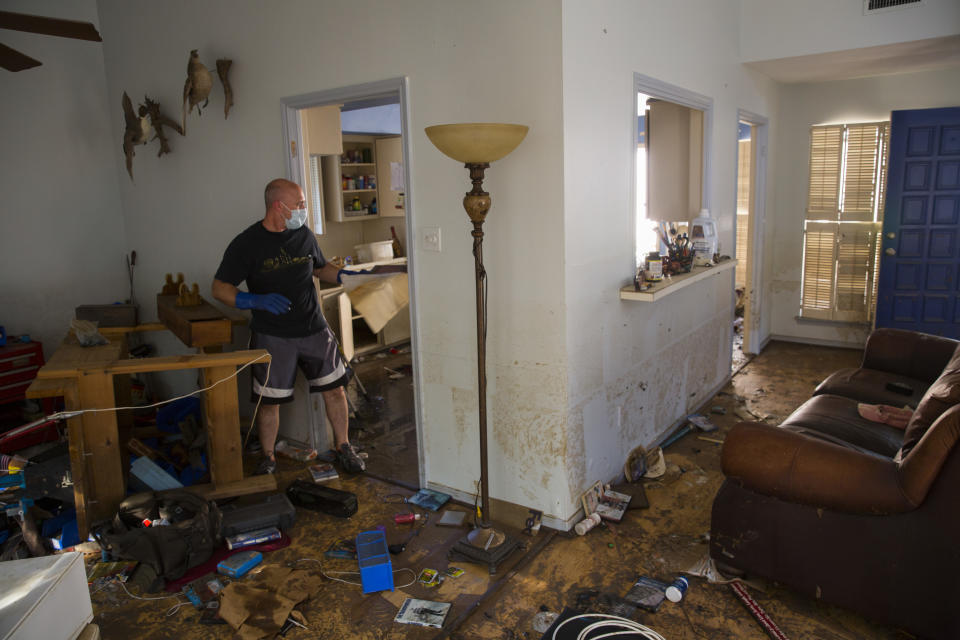 Larry Koser Jr. helps clean up on Sept. 7. (Photo: Erich Schlegel for Yahoo News)