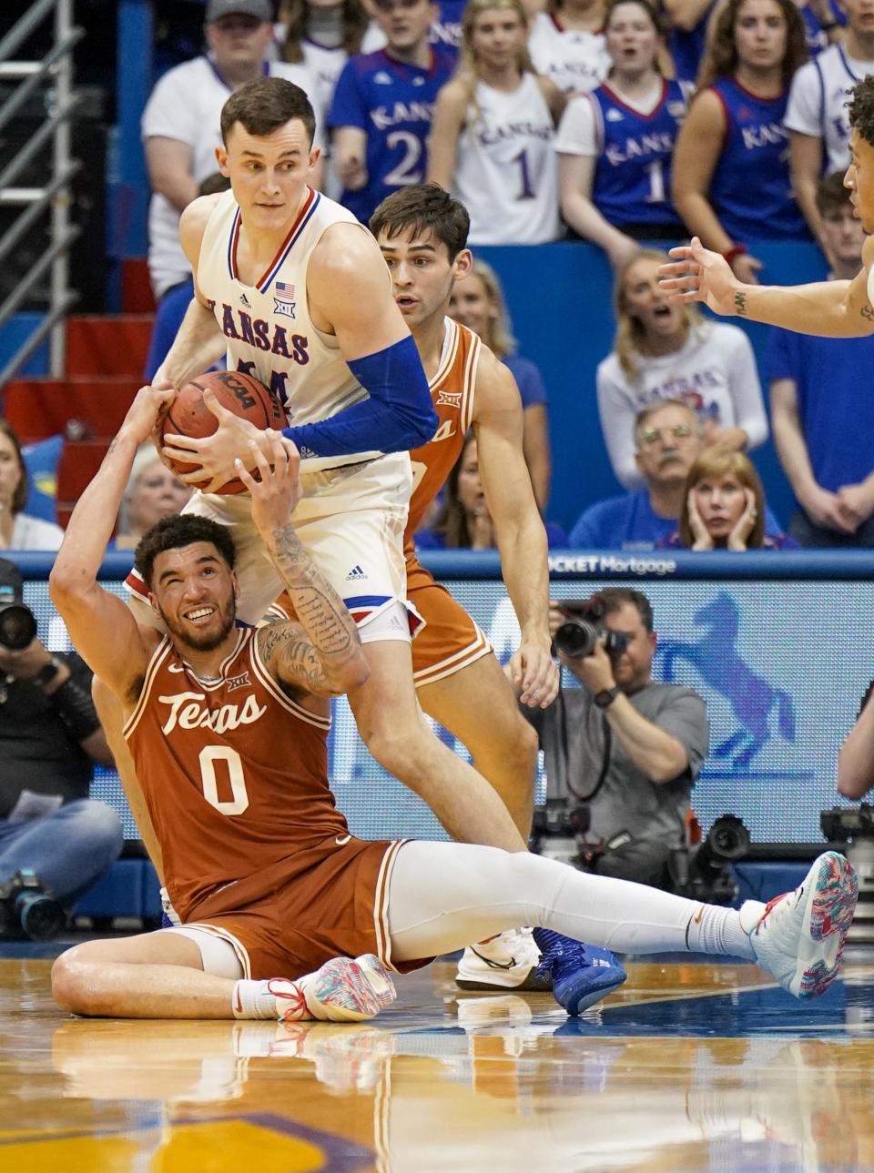 Texas forward Timmy Allen loses the ball to Kansas forward Mitch Lightfoot during the second half of Saturday's Jayhawks victory. Kansas snapped a three-game losing streak to the Longhorns dating back to last season.