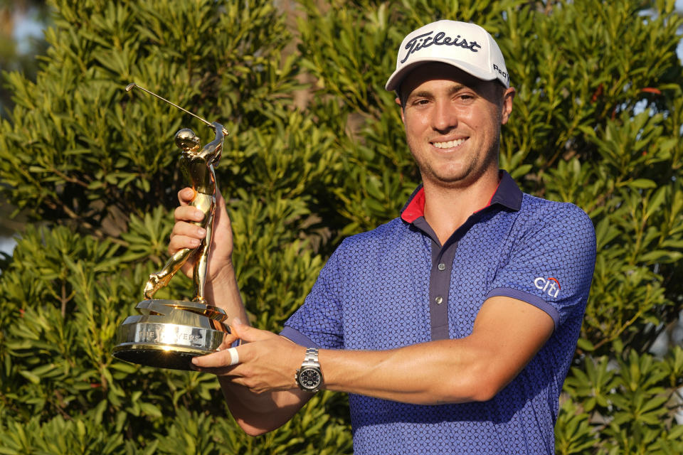 Justin Thomas holds the trophy after winning The Players Championship golf tournament Sunday, March 14, 2021, in Ponte Vedra Beach, Fla. (AP Photo/John Raoux)