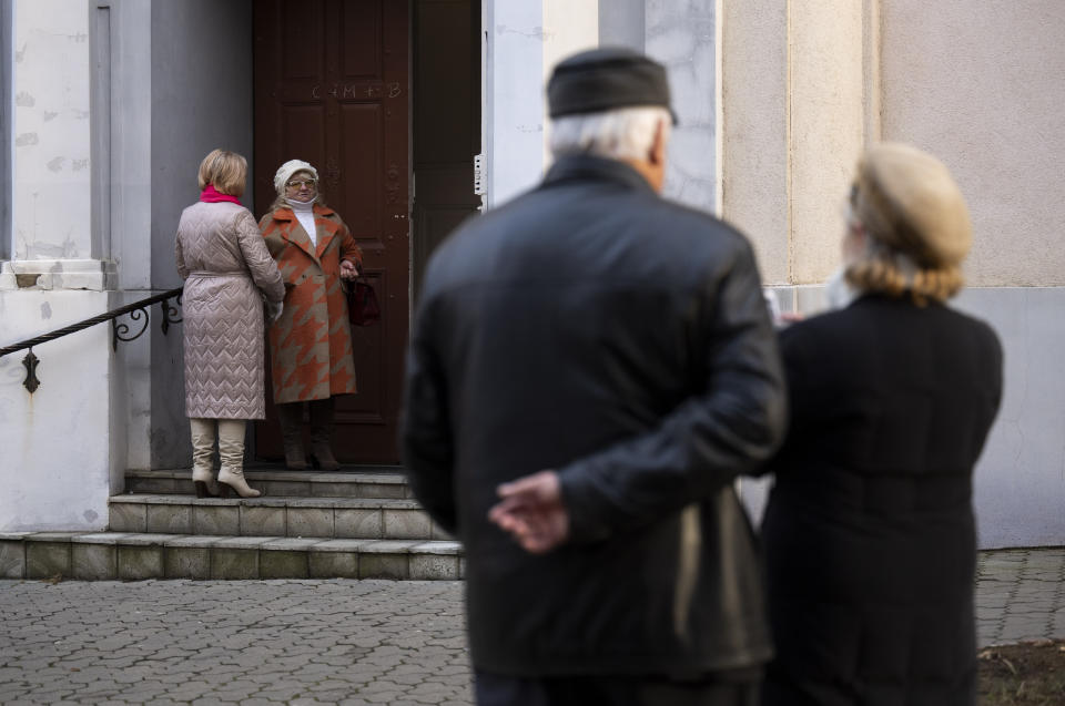 Members of Ukraine's ethnic Hungarian minority gather before a mass at a Catholic church in Uzhhorod, Sunday, Jan. 28, 2024. Ukraine amended its laws to comply with EU membership requirements, and restored many of the language rights for minorities demanded by Budapest but Hungary's government has indicated it is not fully satisfied — a potentially explosive sticking point as EU leaders meet Thursday, Feb 1, 2024 to try and break Orban's veto of a major aid package earmarked for Kyiv. (AP Photo/Denes Erdos)