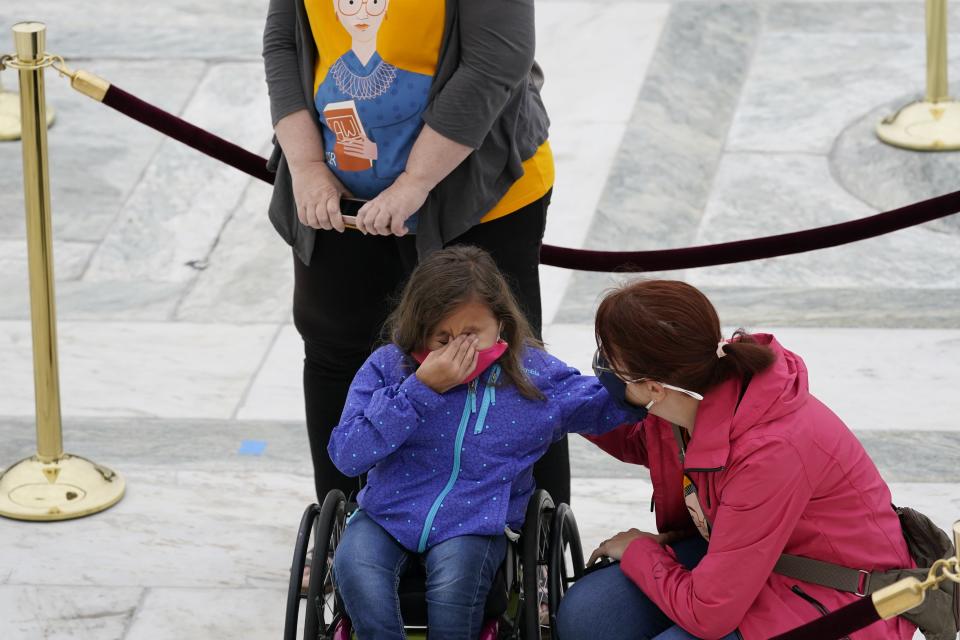 A mourner becomes emotional as she pays respects to Justice Ruth Bader Ginsburg at the the U.S. Supreme Court building on September 24, 2020 in Washington, DC.