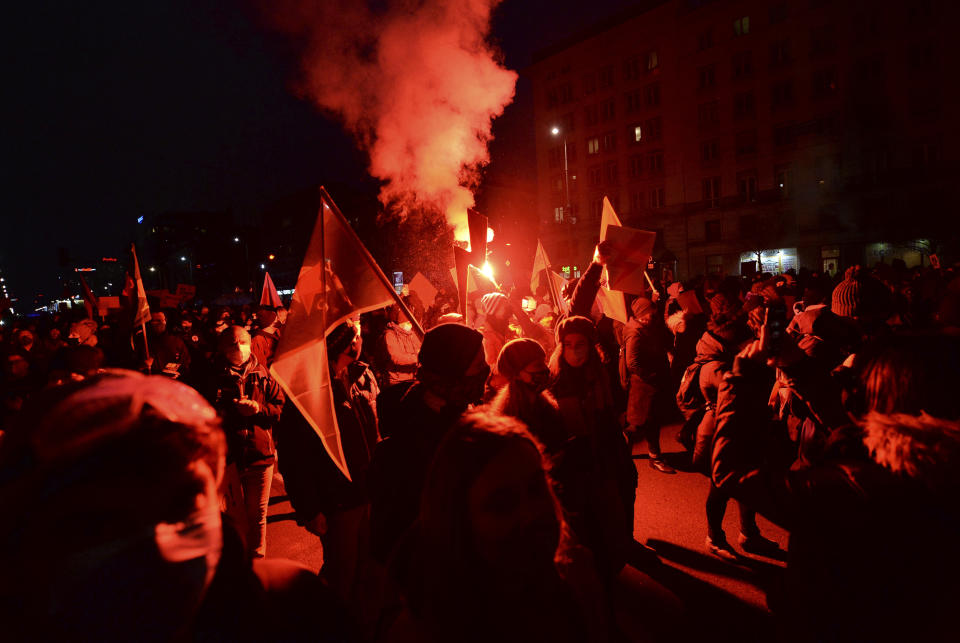 People demonstrate against police violence and an attempted restriction on abortion rights in Warsaw Poland, Saturday, Nov. 28, 2020. Nationwide protests Saturday were scheduled to coincide with Polish women gaining the right to vote 102 years ago. Weeks of protests against a high court's ruling to further restrict Abortion rights have evolved into the largest protest movement since communism fell 30 years ago.(AP Photo/Czarek Sokolowski)