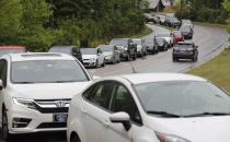 Cars line up on Pine Plaza Drive for gas at the Costco in Apex, N.C., Wednesday, May 12, 2021. Several gas stations in the Southeast reported running out of fuel, primarily because of what analysts say is unwarranted panic-buying among drivers, as the shutdown of a major pipeline by hackers entered its fifth day. (Ethan Hyman/The News & Observer via AP)