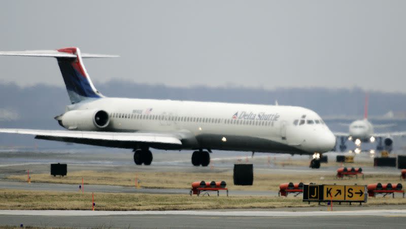 A Delta Shuttle Airlines plane, foreground, taxies in front of a Northwest Airlines plane, rear, at Washington’s Ronald Reagan Washington National Airport, Wednesday, Feb. 20, 2008. Summer travel prices are expected to be high in 2023.