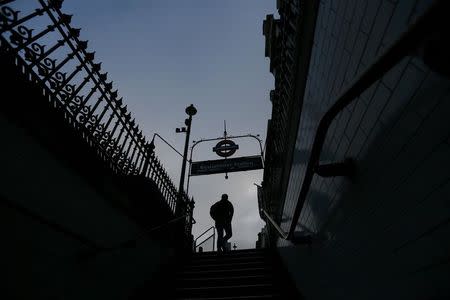 A man silhouetted against the morning sky as he leaves Westminster Tube Station in central London, Britain May 7, 2015. REUTERS/Stefan Wermuth