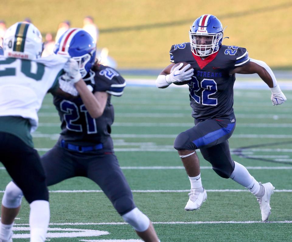 Matthew Sollberger, 22, of Lake runs behind the block of Landon Gardner, 21, during their game against GlenOak at Lake on Friday, Sept. 9, 2022.