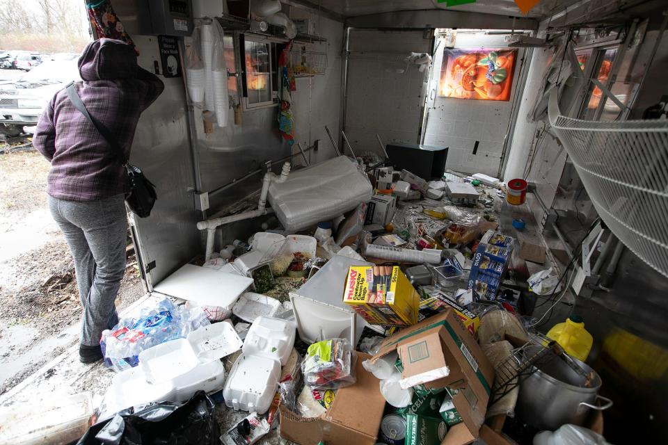 Marcelina Soriano, owner of La Poblanita, a Mexican food trailer usually parked at 3825 Indianola Ave. in Clintonville, breaks down in tears Monday upon seeing what is left of the trailer after it was stolen Saturday morning and stripped of its interior cooking and other equipment. Soriano, who started her business nine years ago, and her four boys came to the Columbus police impound lot Monday to collect the trailer.