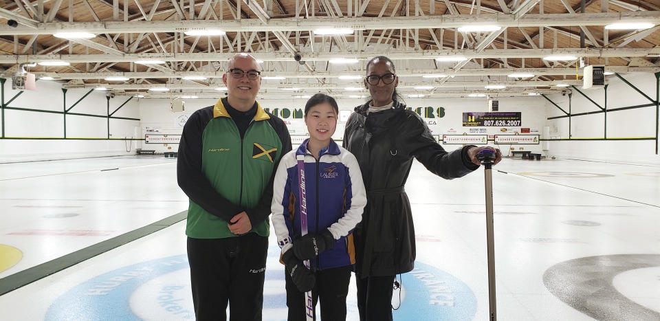 In this photo provided by Curling Jamaica, from left to right, Jamaica's Ben Kong, Stephanie Chen and Cristiene Hall-Teravainen pose for a photo April 30, 2022, during a team curling practice at Port Arthur Curling Club in Thunder Bay, Ontario, Canada. The Jamaican curlers are sliding into the footsteps of the bobsledders that brought the tropical island nation to the Winter Olympics and became an international sensation. (Robert Chen/Curling Jamaica via AP)