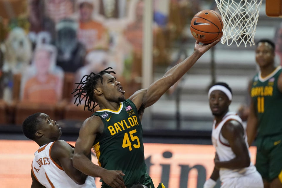 FILE - In this Feb. 2, 2021, file photo, Baylor guard Davion Mitchell (45) drives to the basket past Texas guard Andrew Jones (1) during the second half of an NCAA college basketball game in Austin, Texas. Mitchell is one of the top point guards in the NBA draft after guiding Baylor to the national championship. (AP Photo/Eric Gay, File)