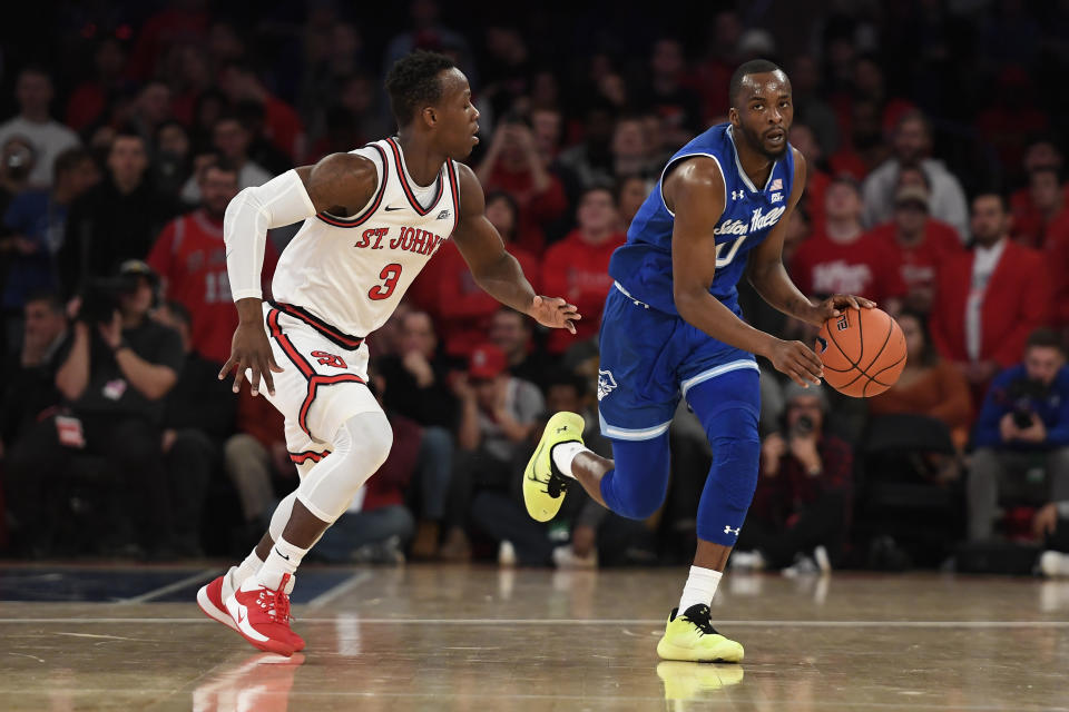 Seton Hall guard Quincy McKnight (0) dribbles the ball against St. John's guard Rasheem Dunn (3) during the first half of an NCAA college basketball game in New York, Saturday, Jan. 18, 2020. (AP Photo/Sarah Stier)