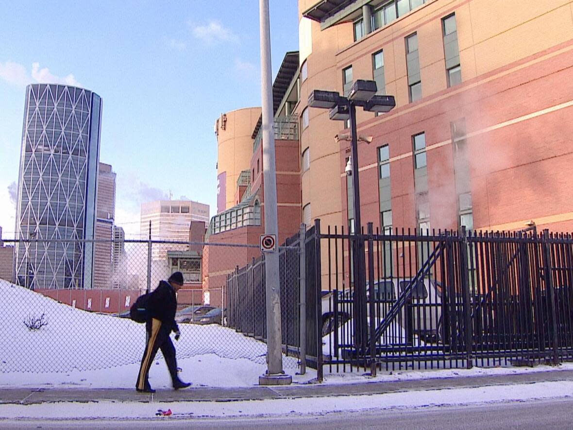 A Calgarian walks past the Drop-In Centre. Recent cold snaps have stretched the resources of the city's homeless shelters.  (James Young/CBC - image credit)