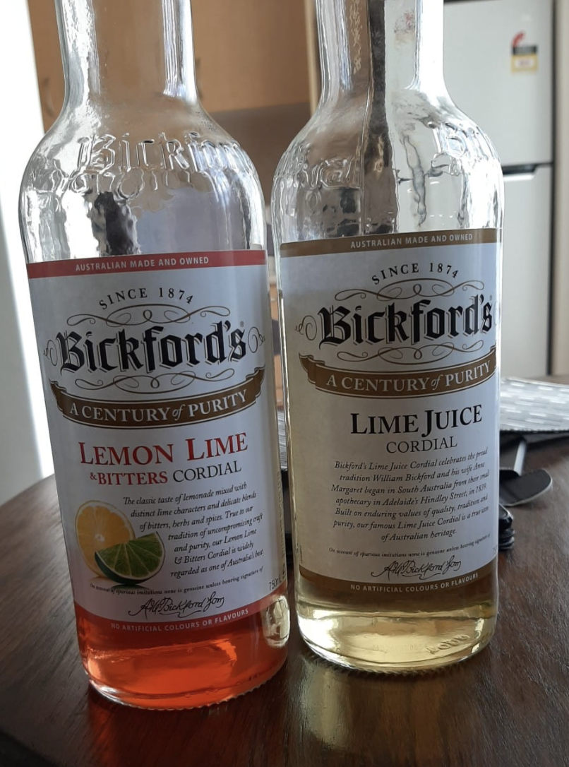 A lemon lime and bitters bottle next to a lime juice cordial from Bickfords.