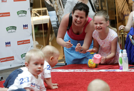 Relatives react as babies take part in the Baby Race to mark international Children's Day in Vilnius, Lithuania, June 1, 2016. REUTERS/Ints Kalnins