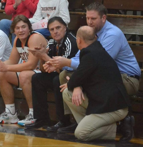 Cheboygan assistant boys basketball coach Scott Hancock, second from left, confers last season with assistant Matt Mylnarchek, head coach Jason Friday and player Dylan Balazovic.