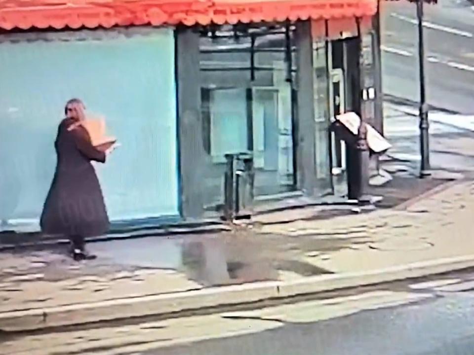 Video appears to show a woman with a box walking to the St Petersberg cafe where a pro-Putin blogger was killed (Unknown)