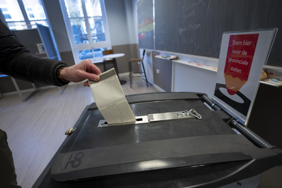 A man casts his ballot for the provincial elections in Amsterdam, Netherlands, Wednesday, March 15, 2023. (AP Photo/Peter Dejong)