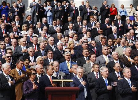 Members of the U.S. Congress stand for the national anthem during a remembrance of lives lost in the 9/11 attacks, at the U.S. Capitol in Washington, September 11, 2013. Bagpipes, bells and a reading of the names of the nearly 3,000 people killed when hijacked jetliners crashed into the World Trade Center, the Pentagon and a Pennsylvania field marked the 12th anniversary of the September 11 attacks in 2001. REUTERS/Jonathan Ernst