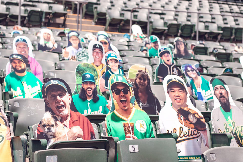 This July 15, 2020, photo provided by the Oakland Athletics baseball team shows fan cutouts in the stands at RingCentral Coliseum in Oakland, Calif., the Athletics home field. The Oakland Athletics offer a wide range of prices, but fans who pay $149 will have cutouts of their likenesses on the first-base side of RingCentral Coliseum plus an autographed photo from outfielder Stephen Piscotty. Proceeds benefit the Piscotty family foundation that’s seeking a cure for ALS, the disease that killed Piscotty’s mother. If a foul ball happens to hit a cutout, the owner receives a baseball signed by Piscotty. (Kyle Skinner/Oakland Athletics via AP)