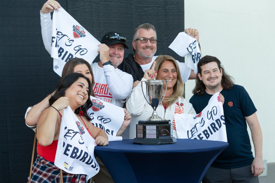 Fans gather outside Acrisure Arena in Palm Desert, CA, taking photos with the Robert W. Clarke trophy, awarded to the AHL Western Conference champions, ahead of Game 1 of  the Coachella Valley Firebirds game against the Hershey Bears on June 8, 2023