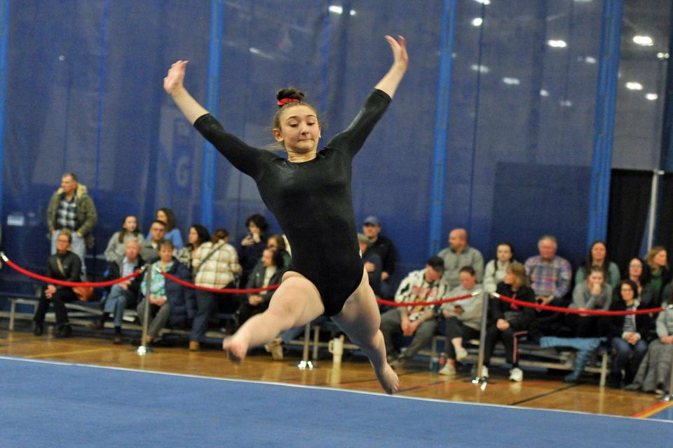 Whitman-Hanson/Duxbury's Emma McKeon leaps during her floor exercise performance at the Patriot League gymnastics meet at Starland in Hanover, Friday, Feb. 9, 2024.