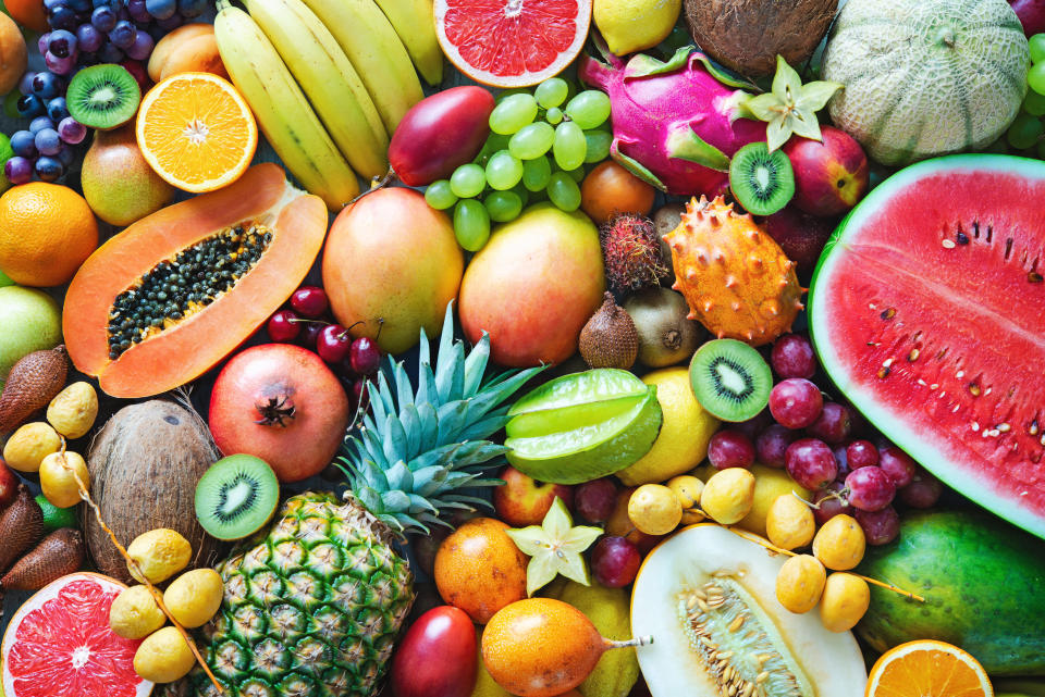 Food background. Assortment of colorful ripe tropical fruits. Top view