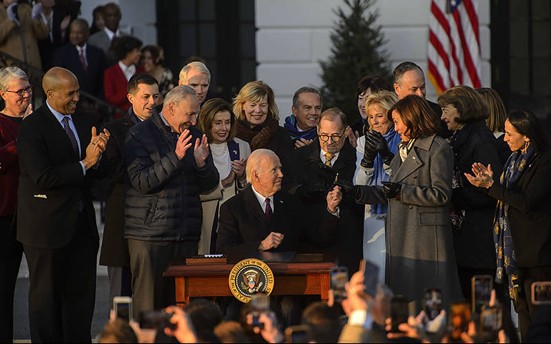 President Biden hands Vice President Harris the pen he used to sign the Respect for Marriage Act during a ceremony on the South Lawn of the White House on Dec. 13. <em>Bonnie Cash/UPI Photo</em>