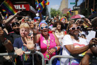 <p>Revelers standing on Seventh Avenue watch the annual Pride Parade on June 24, 2018 in New York City. (Photo: Kena Betancur/Getty Images) </p>