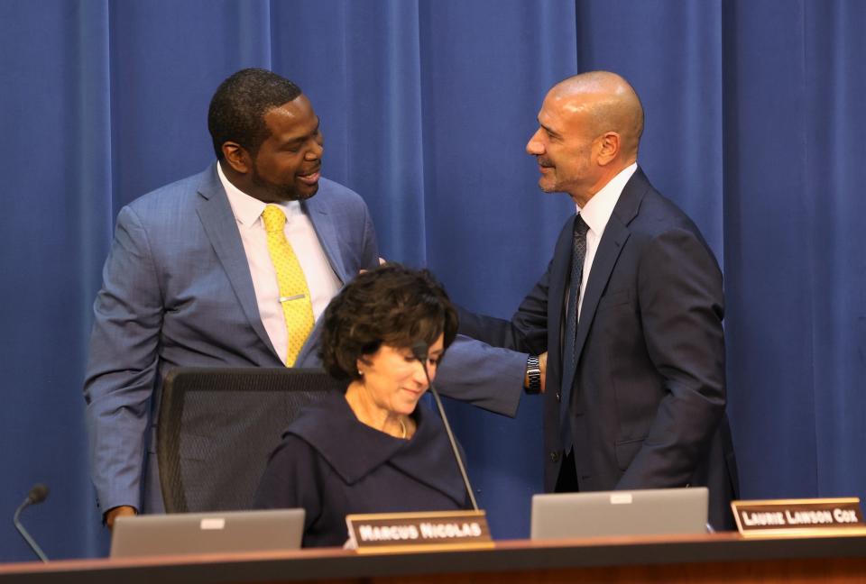 Superintendent Rocky Hanna, right, congratulates newly elected school board member Marcus Nicolas at a Leon County School Board meeting on Tuesday, Nov. 22, 2022.