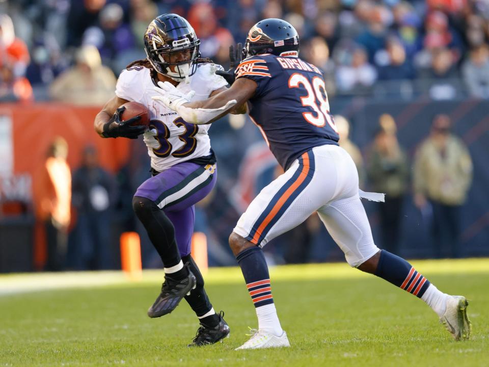 Devonta Freeman fights off a defender against the Chicago Bears.