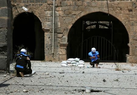 Civil defense members prepare to safely detonate cluster bombs in the rebel-held area in Deraa, Syria July 26, 2017. REUTERS/Alaa al-Faqir