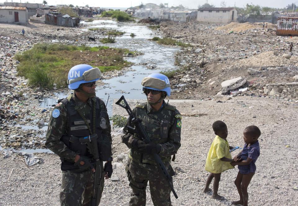 In this Feb. 22, 2017 photo, U.N. peacekeepers from Brazil patrol in the Cite Soleil slum, in Port-au-Prince, Haiti. It took U.N. troops three years to gain control over the sprawling district of Cite Soleil, but it's now placid even though its residents still live in desperate poverty. (AP Photo/Dieu Nalio Chery)