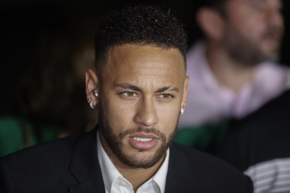 Brazil's soccer player Neymar speaks to the press as he leaves a police station where he answered questions about rape allegations against him in Sao Paulo, Brazil, Thursday, June 13, 2019. Neymar denies any wrongdoing. (AP Photo/Andre Penner)