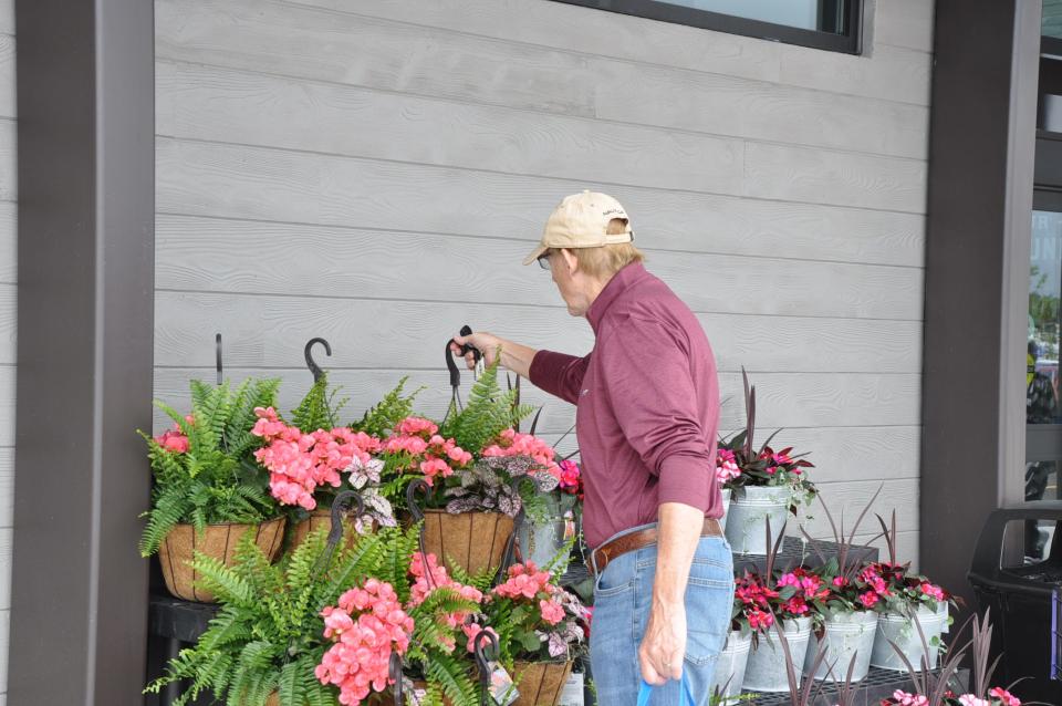 Bob Novak of Perry Township checks out the planters outside Meijer's new North Canton store at 1505 N. Main St. on May 14, 2024.