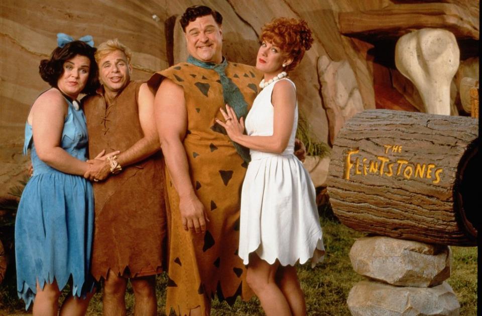 “The Flintstones” premiered in 1994 and also starred Rosie O’Donnell (from left), Rick Moranis, John Goodman and Elizabeth Perkins. Amblin/Universal/Kobal/Shutterstock