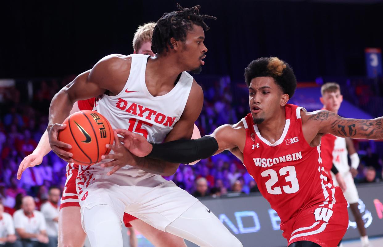 Dayton forward DaRon Holmes II (15) looks for an opening as Wisconsin's Chucky Hepburn defends during a game in November.