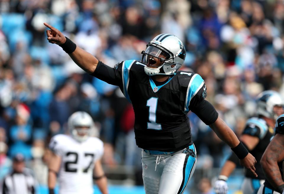 Cam Newton #1 of the Carolina Panthers celebrates after throwing a touchdown pass to teammate Steve Smith #89 during their game against the Oakland Raiders at Bank of America Stadium on December 23, 2012 in Charlotte, North Carolina. (Photo by Streeter Lecka/Getty Images)